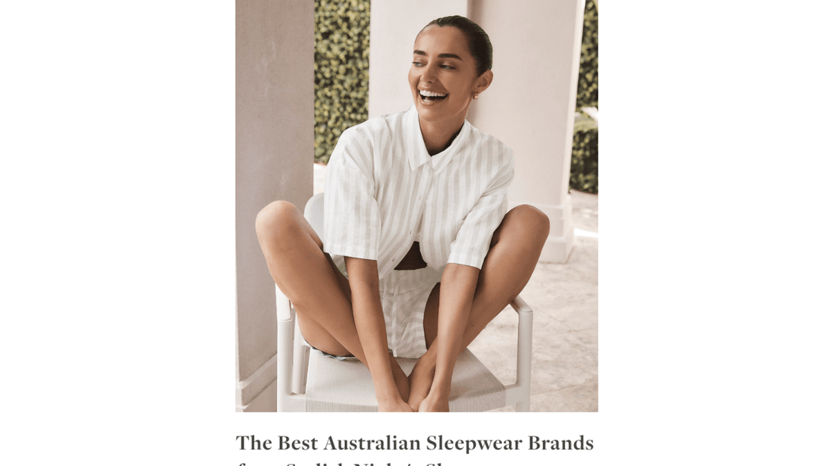 Smiling woman wearing Gingerlilly Sleepwear white striped shirt and shorts outdoors