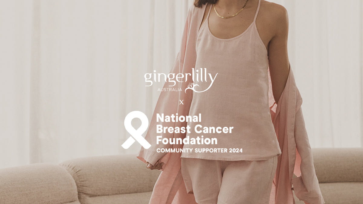 Woman in soft pink Gingerlilly Sleepwear set for breast cancer awareness on beige sofa