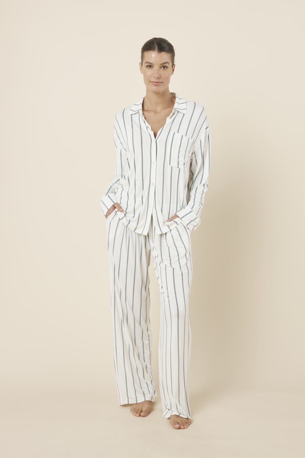 Woman wearing the Harlow Bamboo Striped PJ Set Ivory front view with hands in pockets
