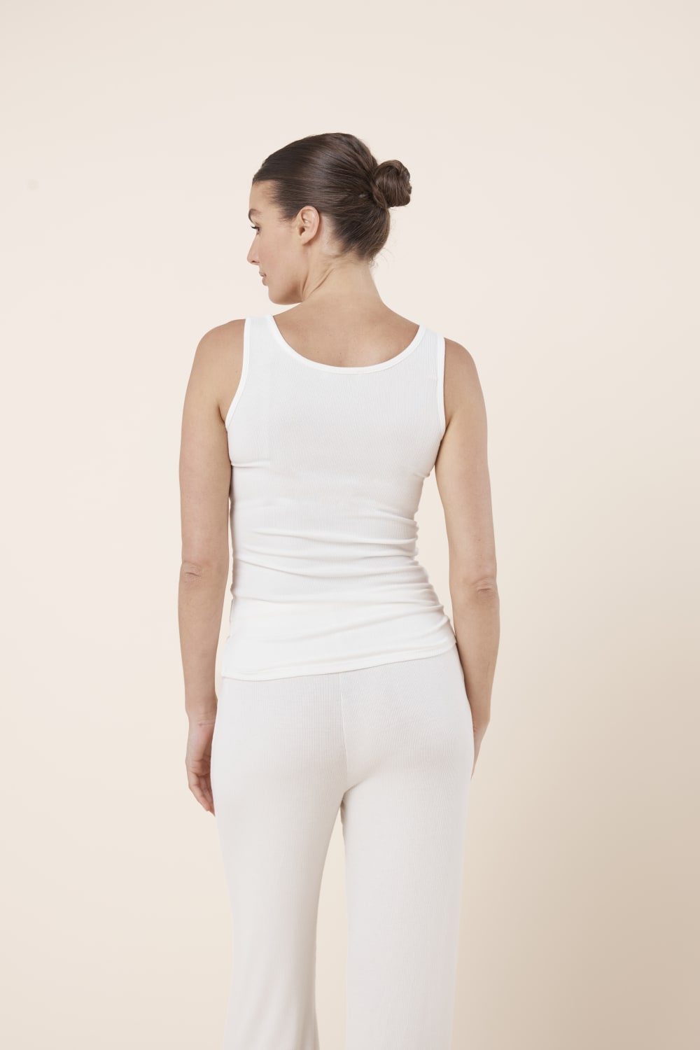 Woman wearing Liberty Ribbed Singlet Henley Top Ivory back view showing fitted ribbed silhouette