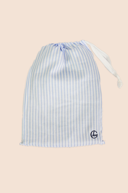 Blue and white striped drawstring bag on a beige background