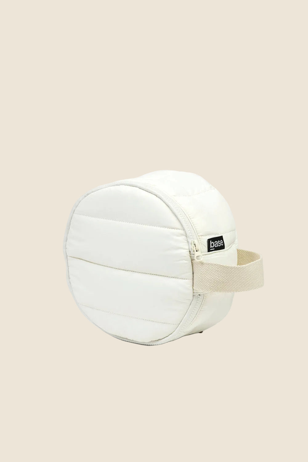 Ecru quilted round toiletry bag with zipper and beige handle, Base label visible