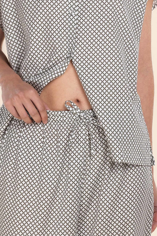 Person wearing a black and white patterned outfit with a focus on the waist area.