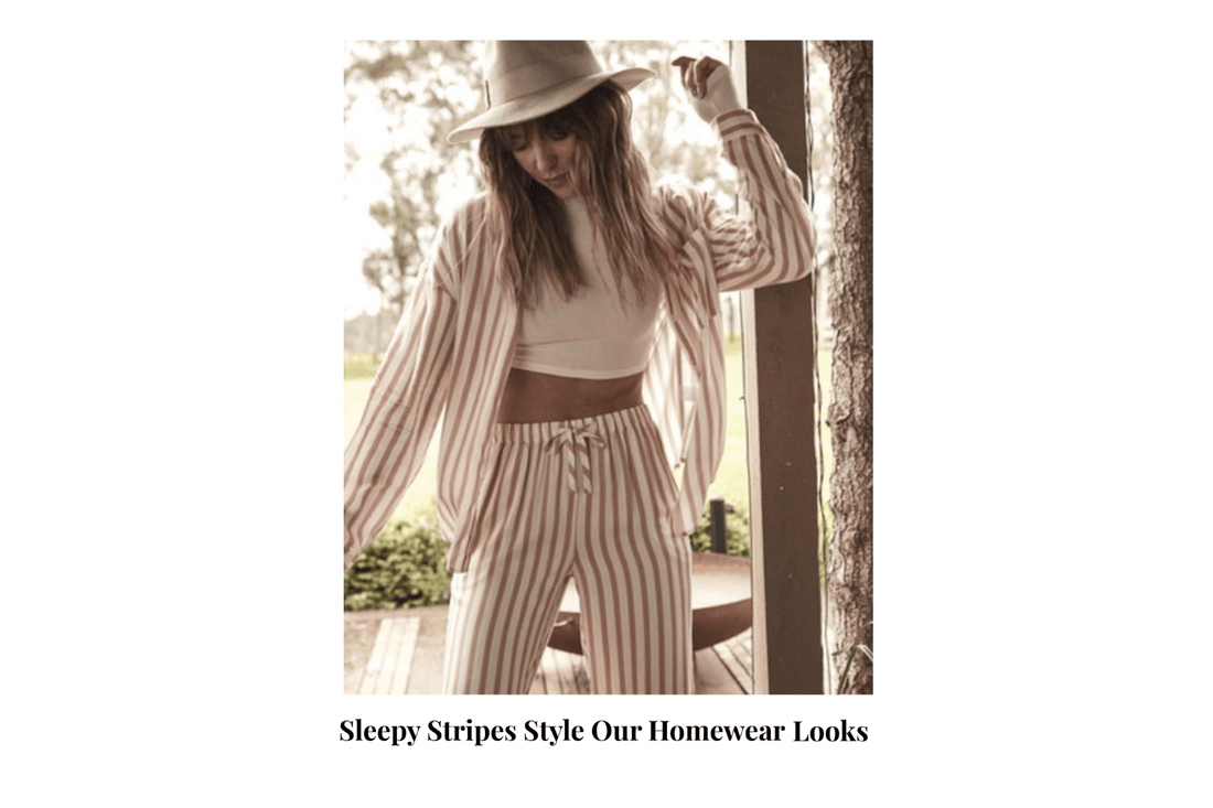 Woman in striped Gingerlilly Sleepwear set and hat, standing outdoors in natural light