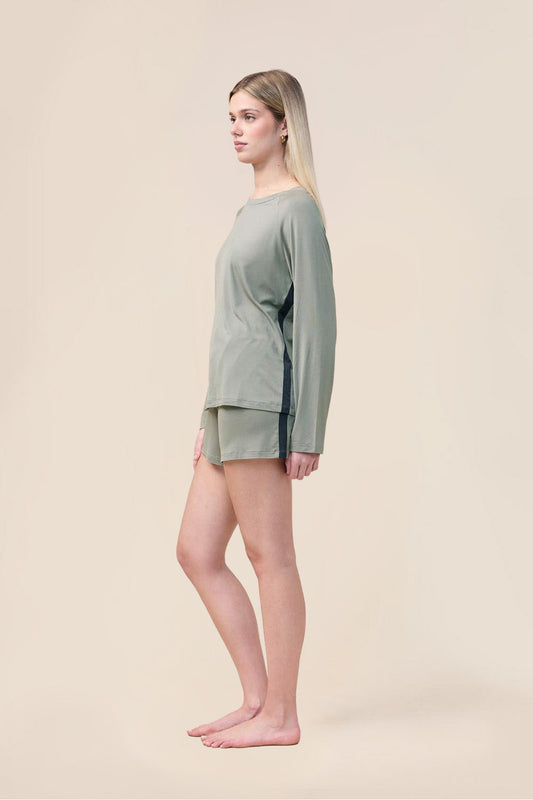 Woman wearing the Solene Long Sleeve Top with Stripe in Olive, side view