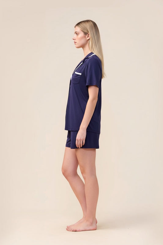 Woman wearing the Allegra Short Bamboo PJ Set in Navy, side view showing white contrast trim