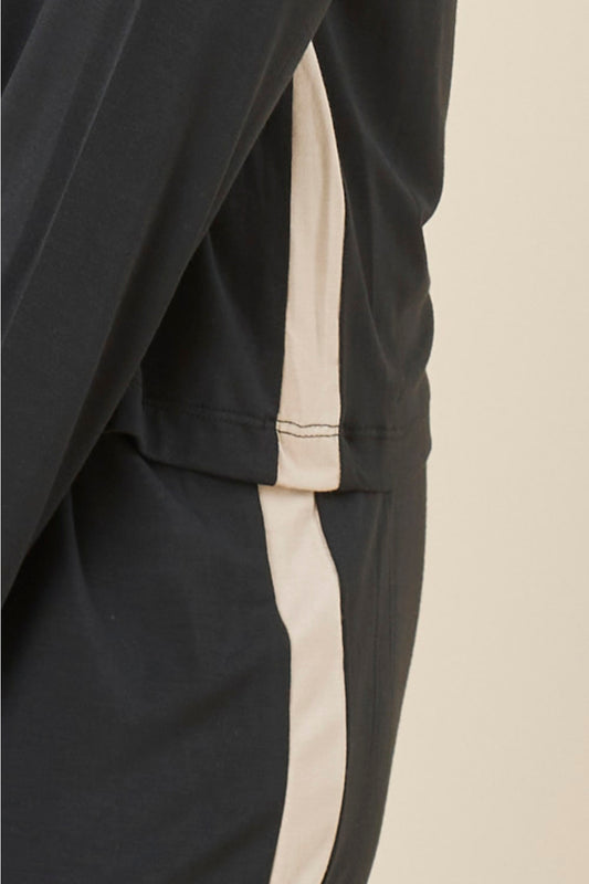 Close up of Anya Bamboo Sporty PJ Set Black pants showing the contrast satin side stripe detail running along the leg.