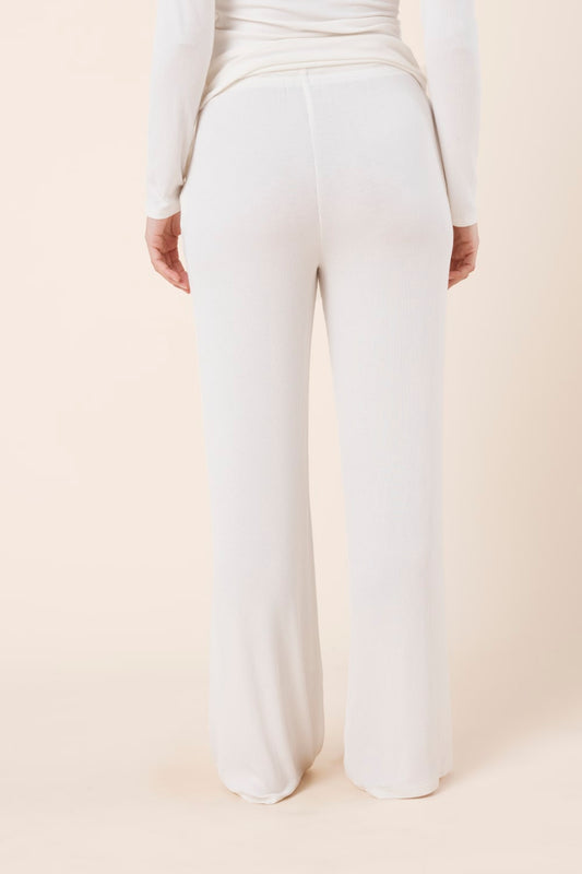 Woman wearing Athens Ribbed Long Pants Ivory, back view of relaxed ribbed wide leg lounge pants