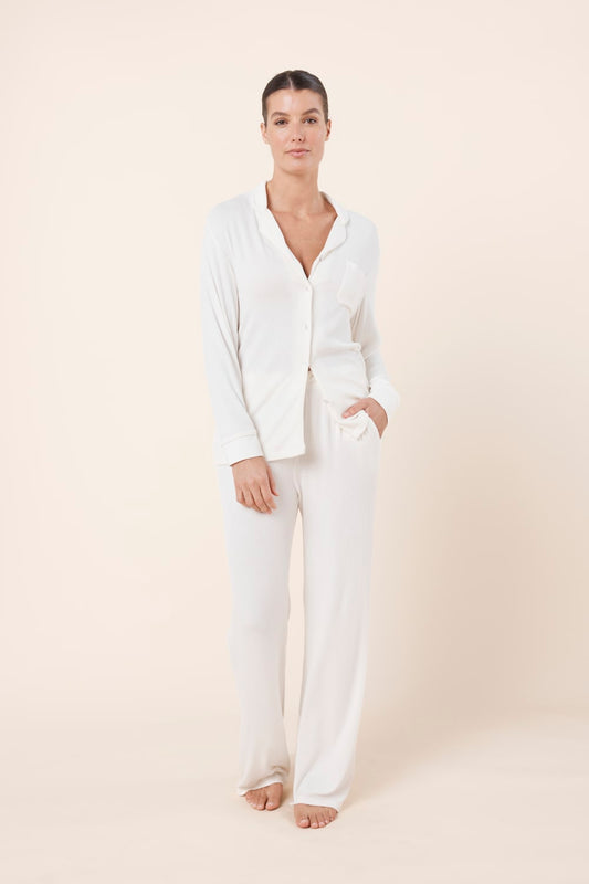 Woman wearing Athens Ribbed Long Pants Ivory, front view of soft ribbed lounge pants with relaxed wide leg fit