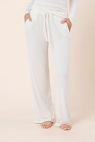 Woman wearing Athens Ribbed Long Pants Ivory, full length view of lightweight ribbed lounge pants with wide leg silhouette