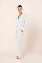 Woman wearing Athens Ribbed Long Pants Ivory styled with matching ribbed lounge top