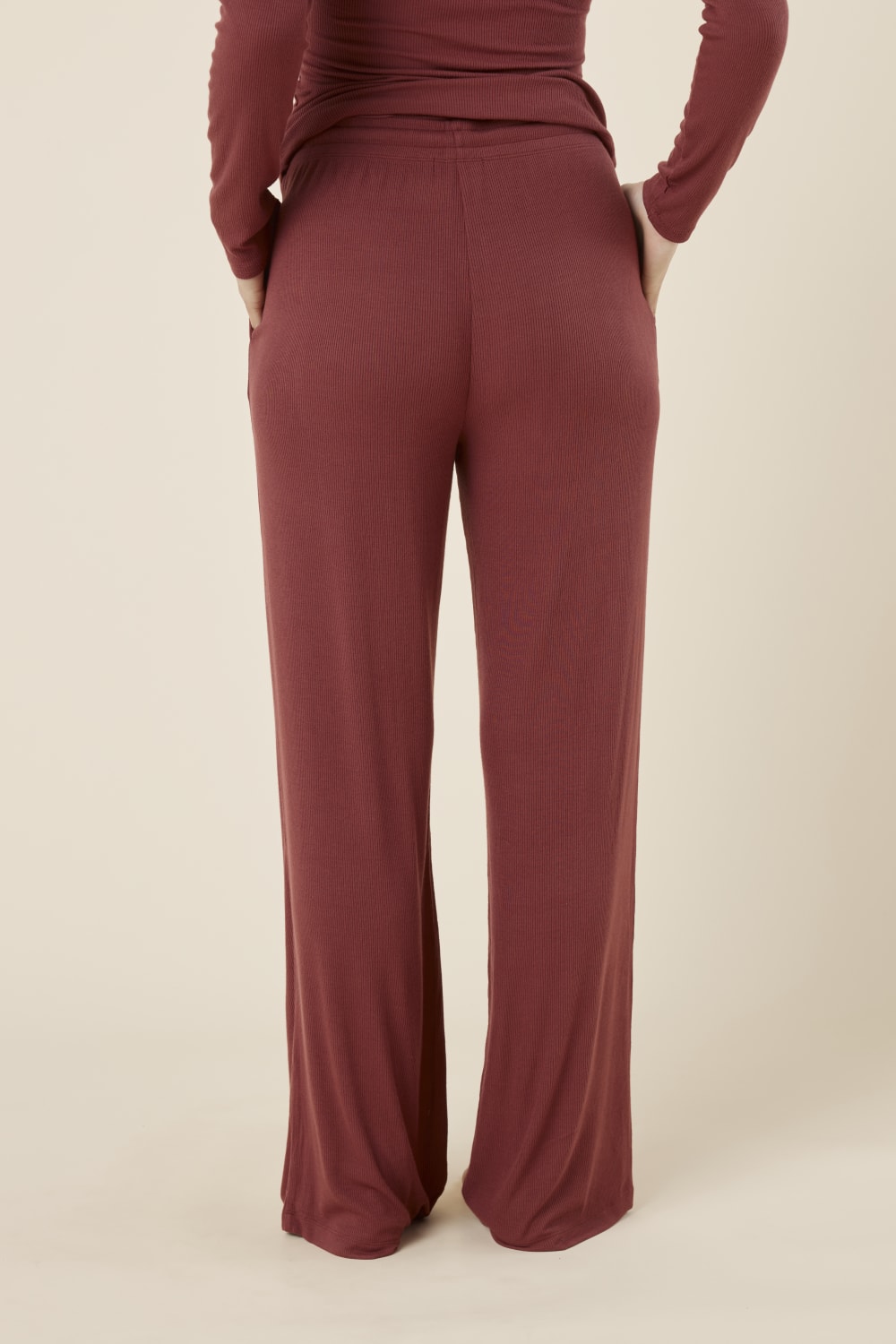 Woman wearing Athens ribbed Long pant burgundy from the back view