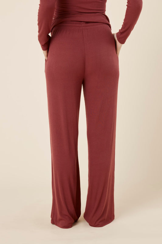 Woman wearing Athens ribbed Long pant burgundy from the back view