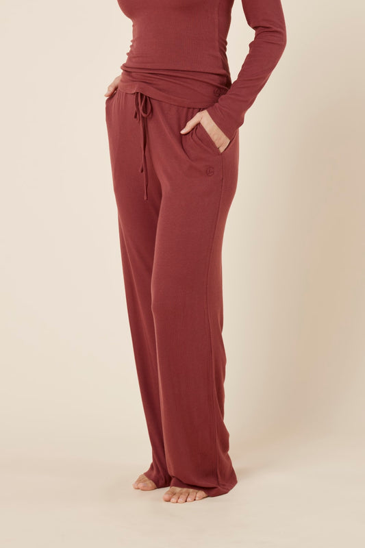 Woman wearing the Athens ribbed Long pant side on view with hand in pocket