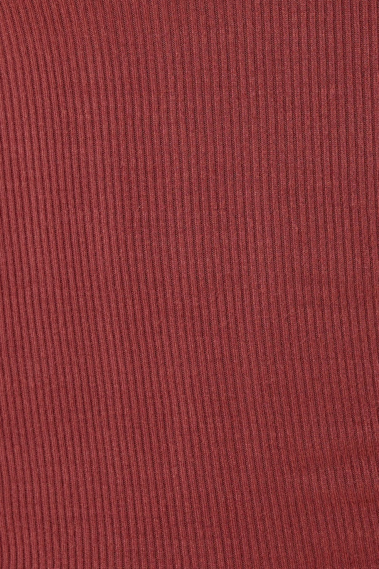 Close-up of a ribbed red fabric texture of the Athens ribbed Long pant burgundy