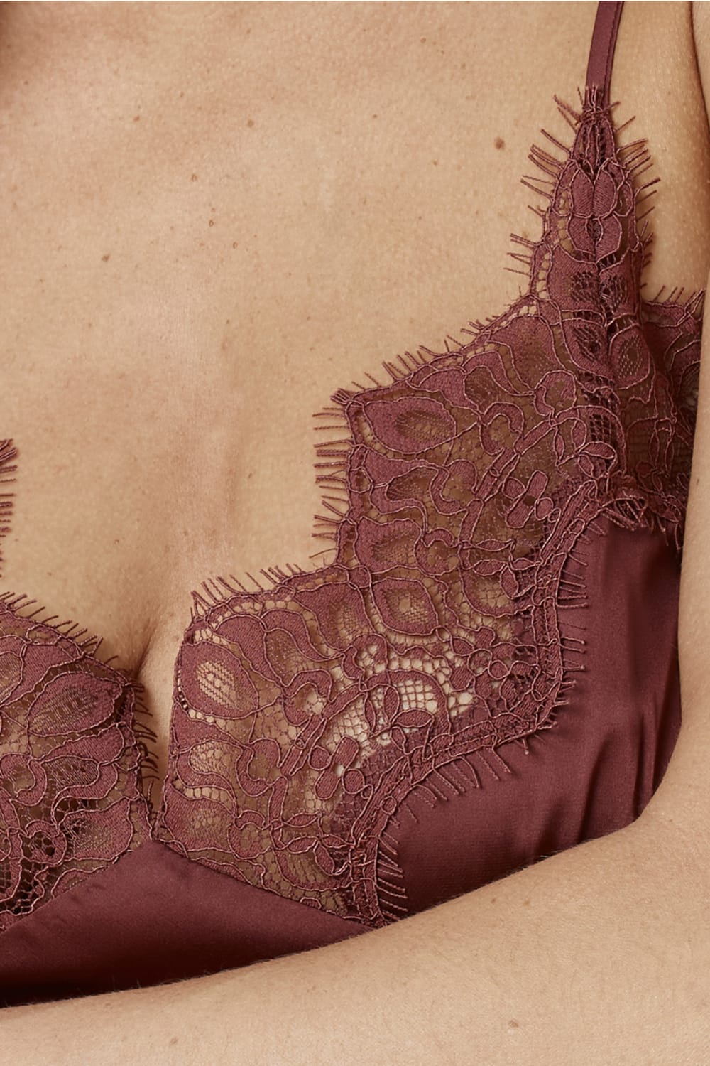 Close up of Azalia Silky Satin Short Chemise Burgundy showing the delicate lace trim at the neckline layered over smooth satin fabric.