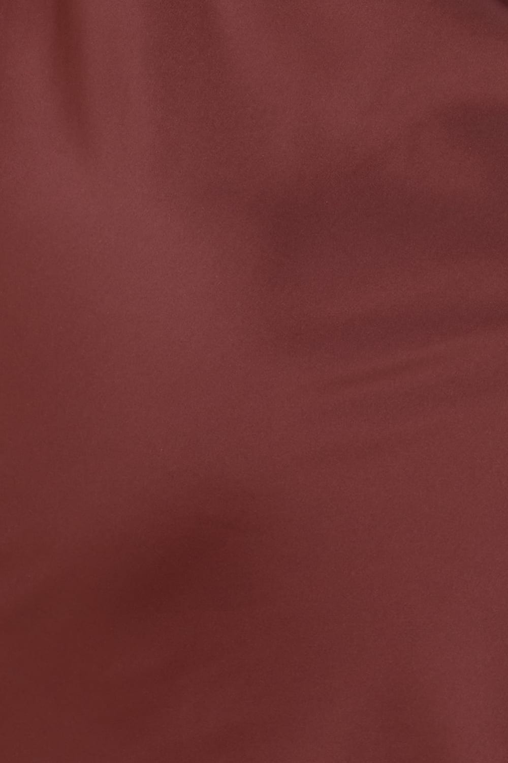 Close up of Azalia Silky Satin Short Chemise Burgundy fabric showing the smooth satin texture and rich burgundy colour with a soft sheen.