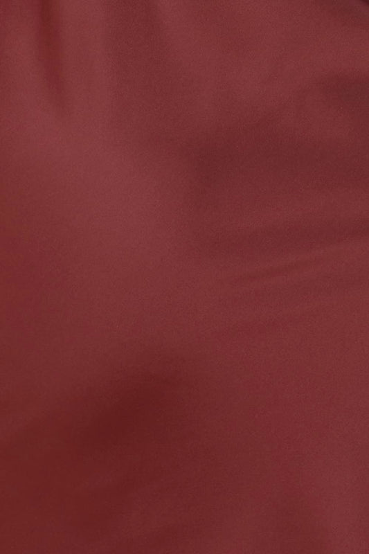 Close up of Azalia Silky Satin Short Chemise Burgundy fabric showing the smooth satin texture and rich burgundy colour with a soft sheen.