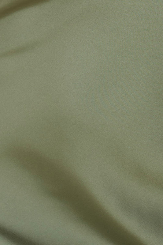 Close up of Azalia Silky Satin Short Chemise Olive fabric showing the smooth silky satin texture and soft olive green colour with gentle sheen.