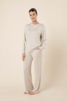 Woman wearing a brianna lounge set oatmeal on a plain beige background side on view