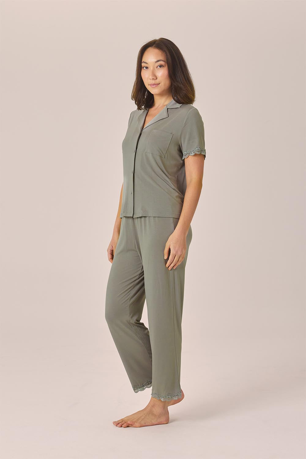 Woman wearing the Dianne Bamboo Long PJ Set with Lace in Olive, angled front view