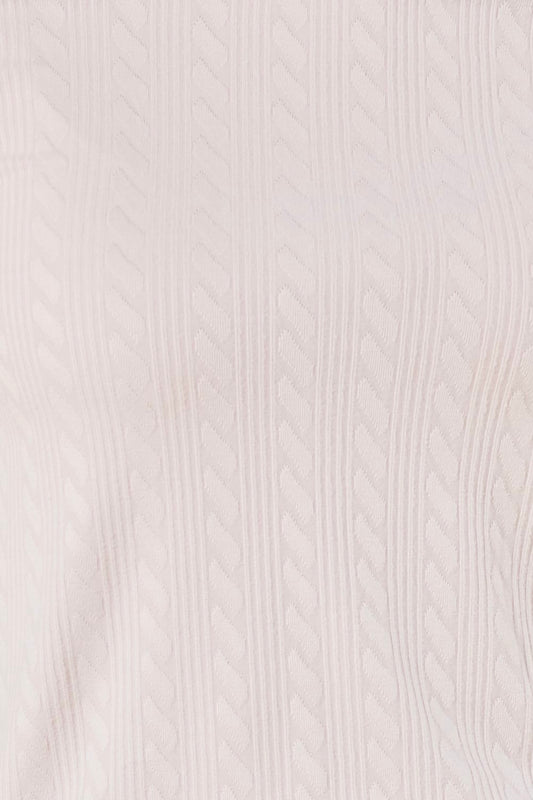 Close-up of a pink textured fabric of the ellie lightweight velour cable knit showing the pattern