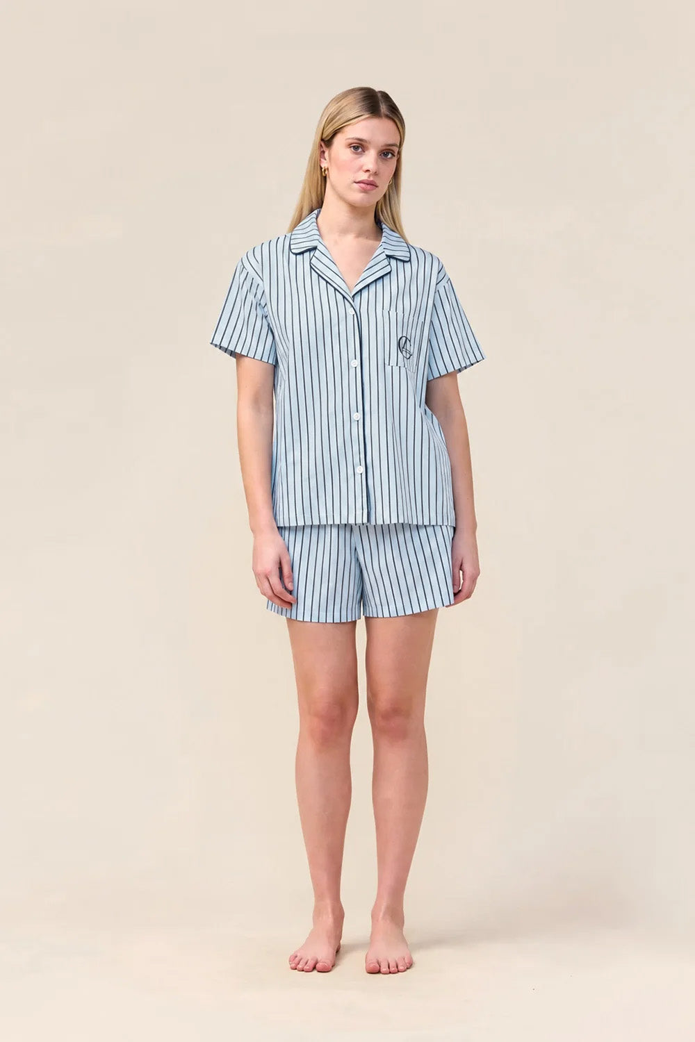 Woman wearing the Poppy Stripe Short PJ Set in Blue, front view of short sleeve shirt and shorts