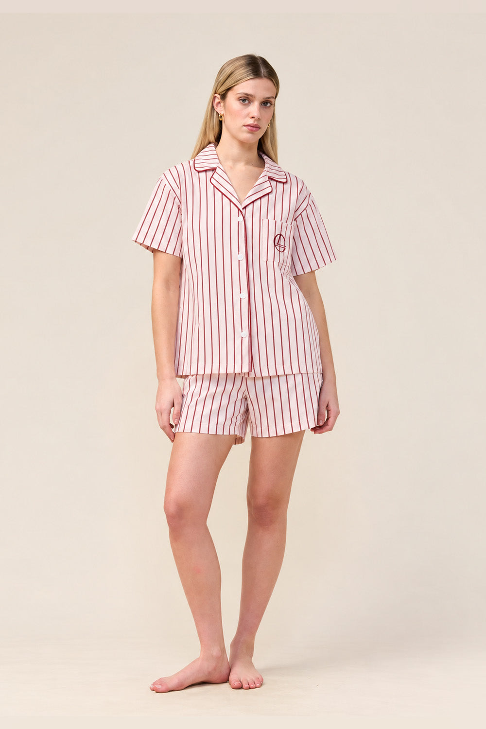 Woman wearing the Poppy Stripe Short PJ Set in Pink, front view of short sleeve shirt and shorts