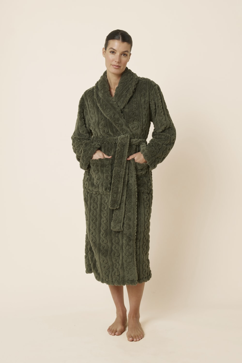 Woman wearing a olive green Gabriella Plush Long Robe with hands in both front pockets and waist tie done up