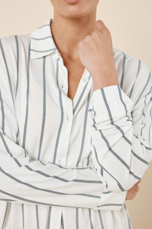 Woman wearing a Harlow Bamboo Striped pyjama PJ Set Ivory with sleeves showing