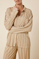 Woman wearing the Biscuit Harlow Bamboo Striped PJ Set biscuit front view cropped showing buttons and white stripes