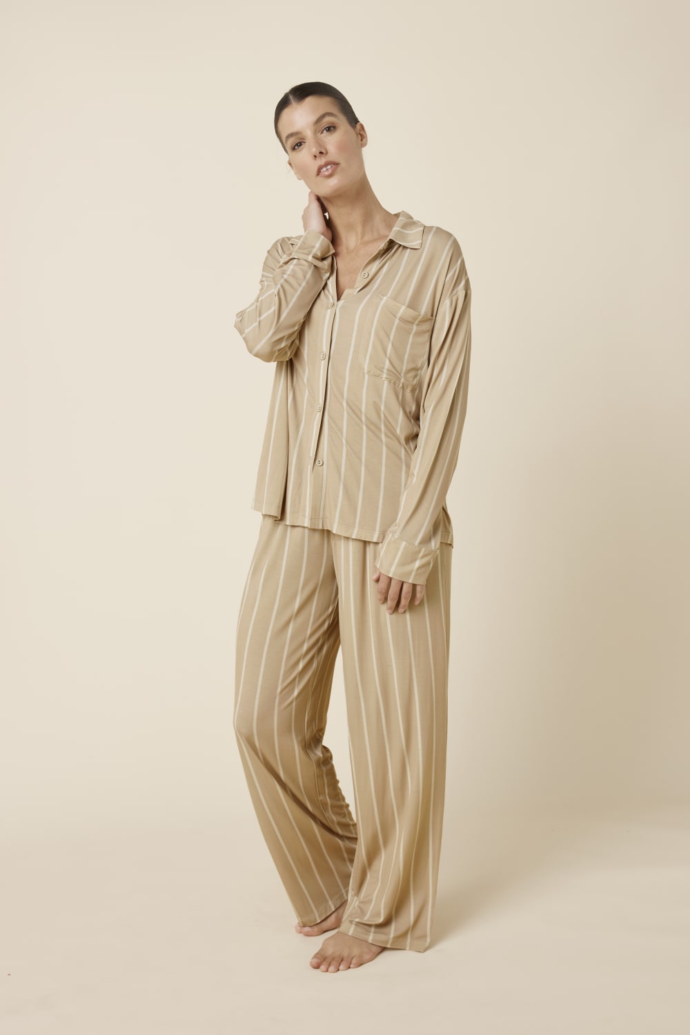 Woman wearing Harlow Bamboo Striped pyjama PJ Set in biscuit with white stripes from a side on view
