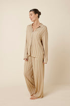 Woman wearing a Harlow Bamboo Striped pyjama PJ Set biscuit from side on view