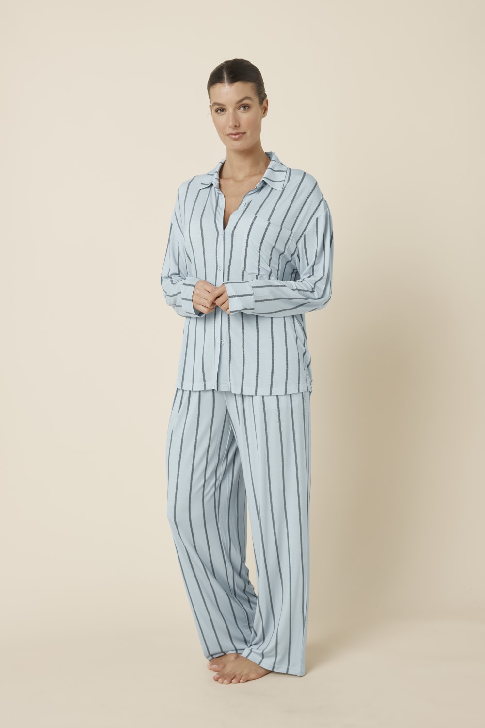 Woman wearing a light blue Harlow Bamboo Striped pyjama PJ Set side on view