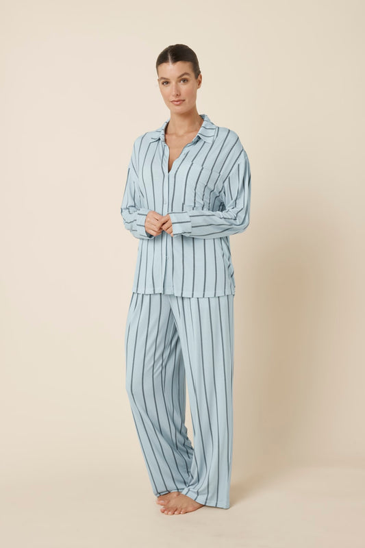 Woman wearing a light blue Harlow Bamboo Striped pyjama PJ Set side on view