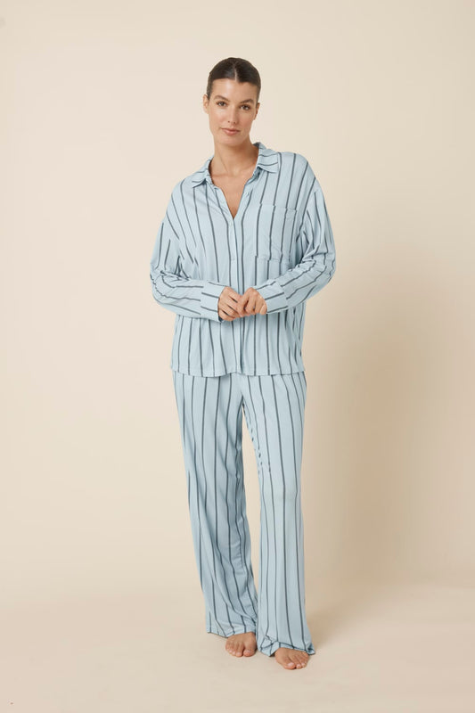 Woman wearing a light blue Harlow Bamboo Striped pyjama PJ Set from a front on view with hands together