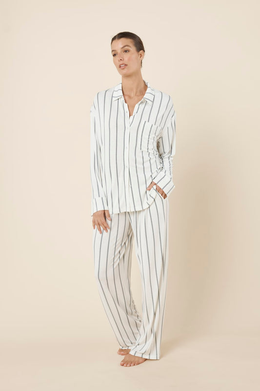 Woman wearing a white ivory Harlow Bamboo Striped PJ Set with one hand in pocket side on view