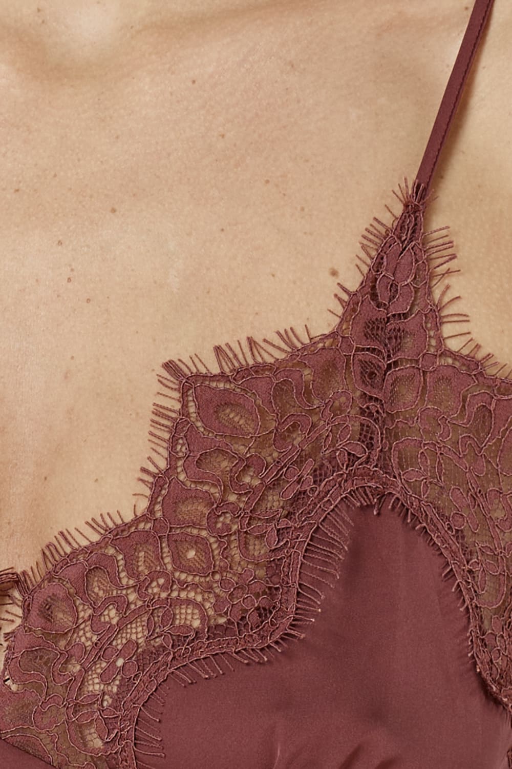 Close-up of a lace-trimmed garment on a beige background
