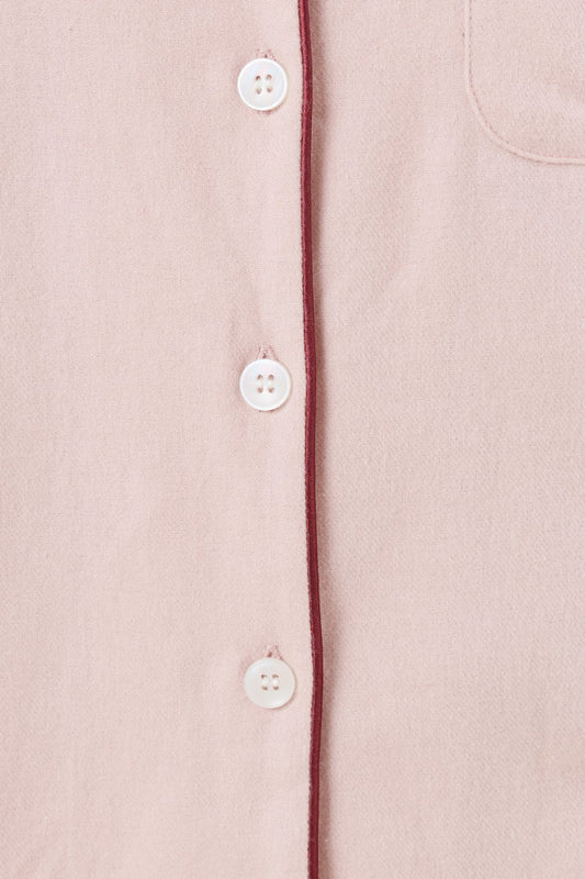 Close up view of pink isabella brushed cotton pyjama PJ set top white buttons and contrast red burgundy piping detail. 