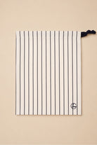 Willow Cotton Stripe PJ Set in Ivory shown with its matching ivory striped drawstring bag