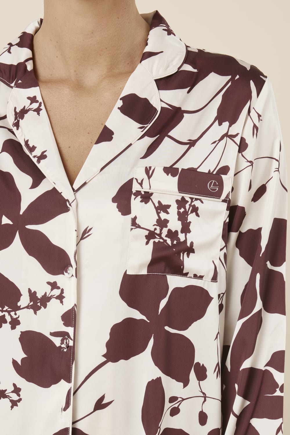 Floral patterned Ivy Silky Satin pyjama PJ set burgundy close up view of the top with pocket and gingerlilly embroidery and buttons