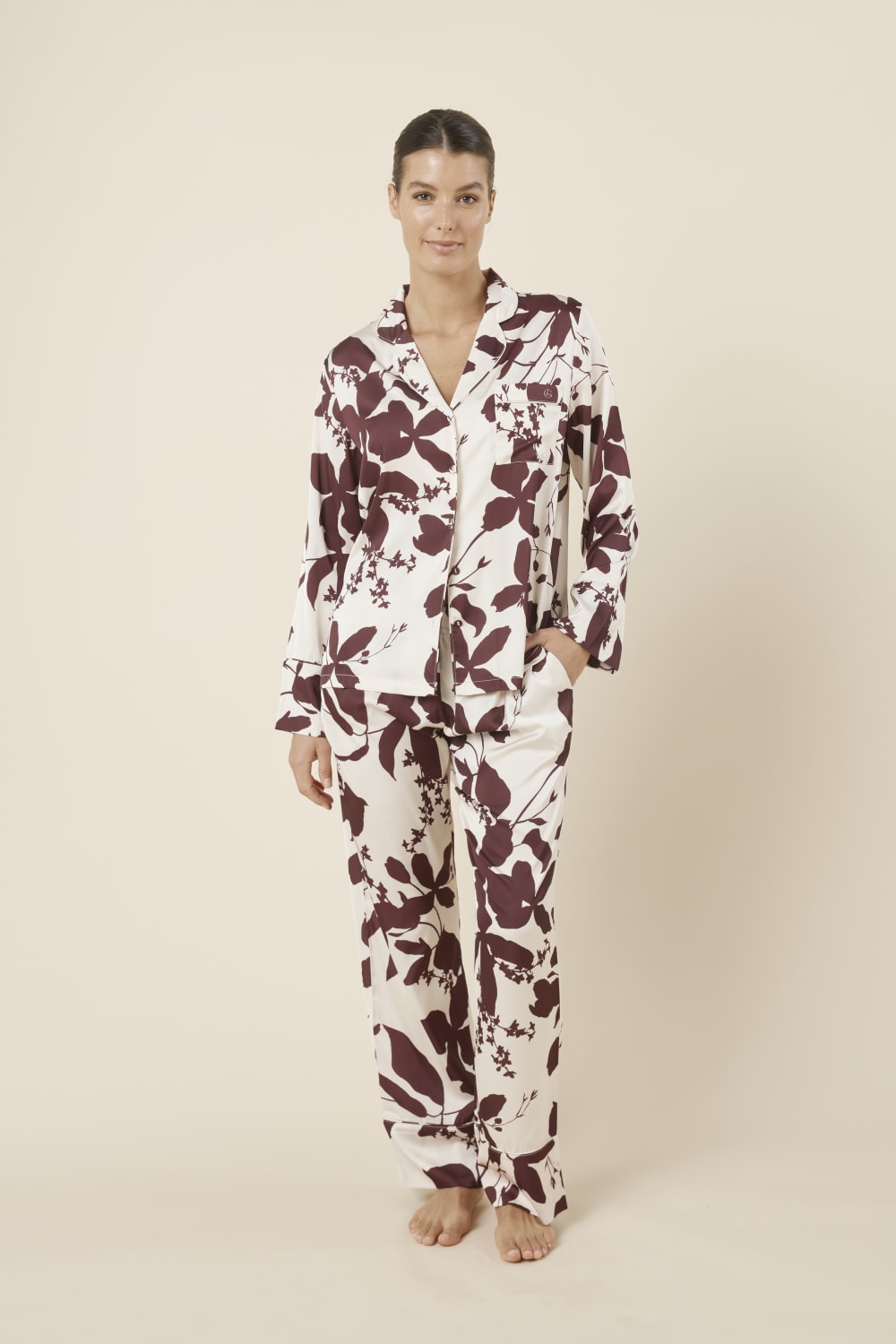 Woman wearing a floral Ivy Silky Satin pyjama PJ front on view with one hand in pocket