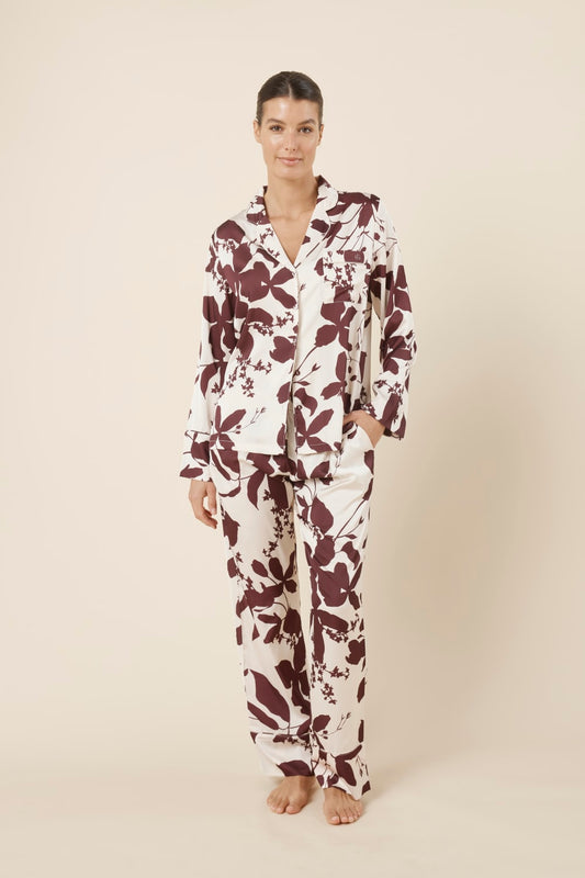 Woman wearing a floral Ivy Silky Satin pyjama PJ front on view with one hand in pocket
