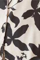 Close-up of the Ivy Silky Satin pyjama PJ set with black floral pattern and white buttons