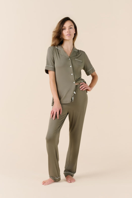 Woman wearing a green pajama set on a beige background