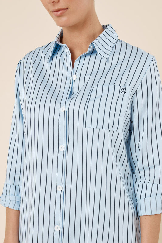 Light blue and white striped shirt worn by a person on a beige background