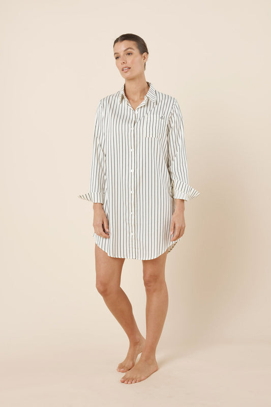 Woman wearing a striped nightshirt on a beige background