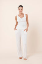 Woman wearing Liberty Ribbed Singlet Henley Top Ivory front view with ribbed texture and henley button detail