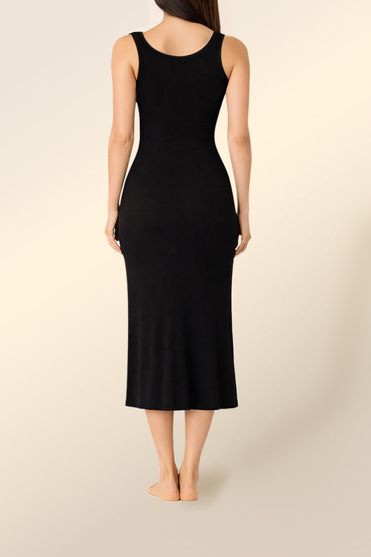 Woman wearing Monique Long Sleeveless Henley Dress Black full length back view showing fitted ribbed midi silhouette