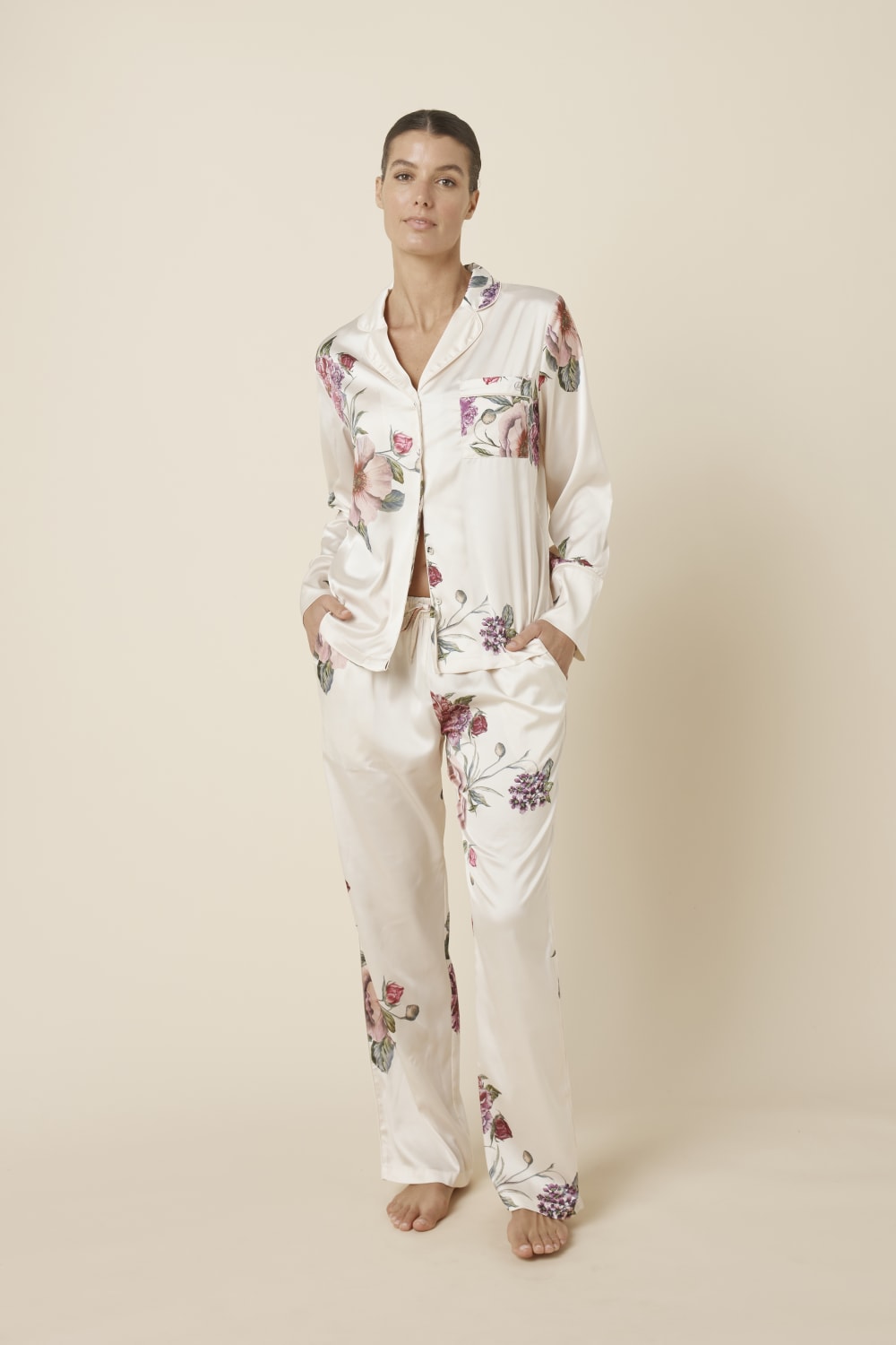 Woman wearing a Ruby Floral Satin PJ set Ivory front view against a plain background